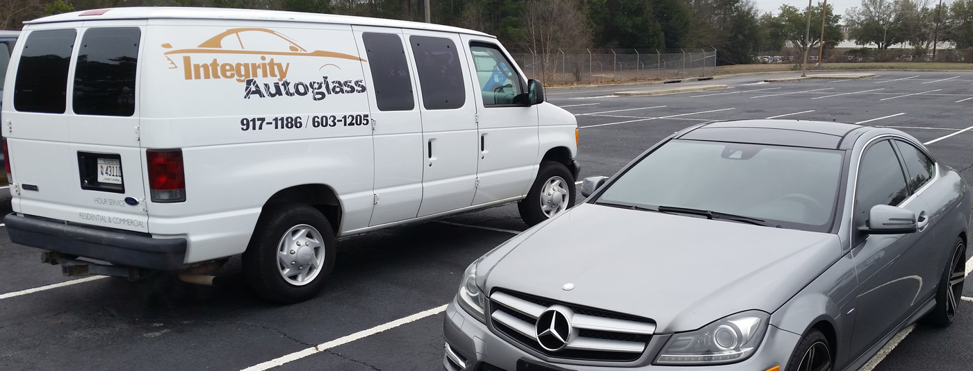 Integrity Autoglass van pictured next to customer vehicle after windshield replacement